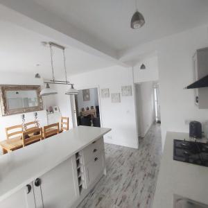 a kitchen and living room with white walls and a table at Havendene in Haworth