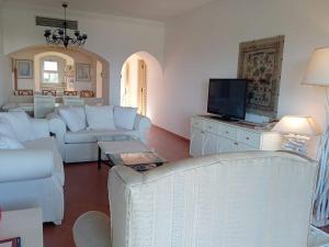 a living room with white furniture and a flat screen tv at Villa bianca sul mar rosso R23124 appartamento luxury Domina in Sharm El Sheikh