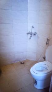 a bathroom with a toilet and a shower at Goroomgo Blue Bell Bhubaneswar in Bhubaneshwar