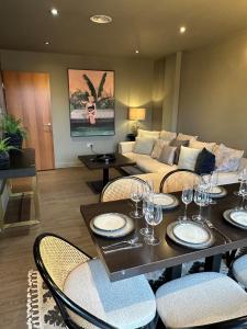 a living room with a table and chairs and a couch at Tunnage Square Apartments Duke St by EPIC in Liverpool