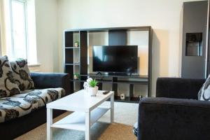 a living room with two couches and a tv at Cosy 2-Bedroom Flat in Warrington in Warrington