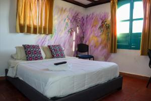 Postel nebo postele na pokoji v ubytování Hotel FLORA Suesca