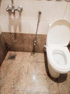 a bathroom with a toilet and a shower at Go Room Hotel Lahore in Lahore