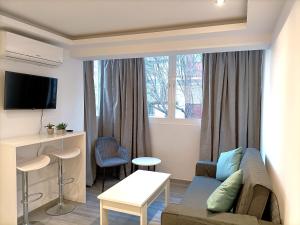 a living room with a couch and a table at Marbella-Peñuelas Old Town Apartments in Marbella