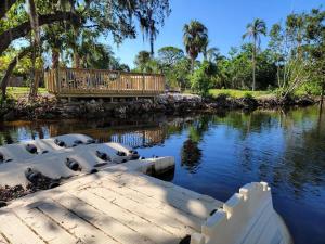 a bridge over a body of water with trees and water at Seahorse - Tiny Home 1.2 Mi, 2 Beach Kitchen W & D Queen Bed in Bonita Springs