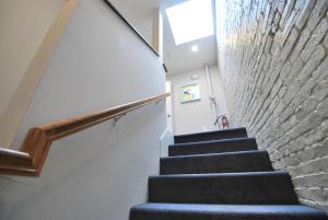 a stairway with a stone wall and stair case at West Broadway Quarters by Thatch in Boston