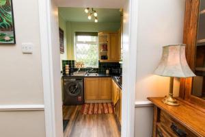 a kitchen with a washing machine and a lamp at Peak Period Property in Chesterfield