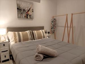 a bedroom with a bed with a towel on it at Marbella-Peñuelas Old Town Apartments in Marbella