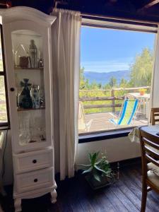 a room with a window with a view of a deck at Otto House in San Carlos de Bariloche