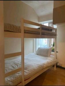 a bedroom with two bunk beds in a room at 47R Place in Dagenham