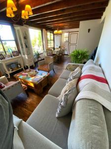 a living room with several couches and a table at Otto House in San Carlos de Bariloche
