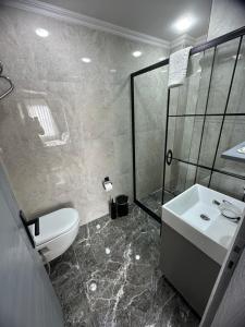 a bathroom with a sink and a toilet and a shower at Big Orange Hotel Old City in Istanbul