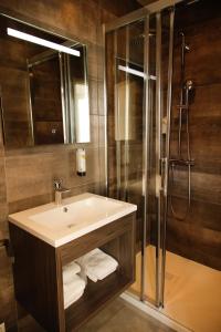 a bathroom with a sink and a shower at Hôtel de France Vire in Vire