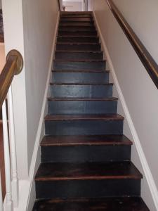 a set of stairs with black and wood treads at Urban Adventure Townhome - Near Downtown Atlanta in Atlanta