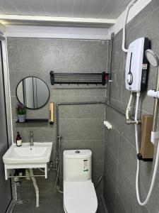 a small bathroom with a toilet and a sink at MostPopular!!! Hay Cafe TranquilFields - OnlyYou with Hay, Rentable For Event in Sekincan