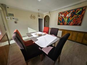 a dining room with a white table and chairs at Mas Sara in Cabanes