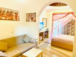 a living room with a couch and a bed at Jewel Howard Carter Hotel in Luxor