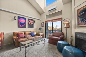 a living room with a couch and a fireplace at Powder Pointe A-205 in Park City