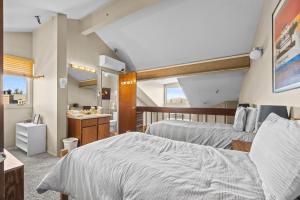 a bedroom with two beds and a bathroom at Powder Pointe A-205 in Park City