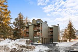 a building in the winter with snow in front of it at Powder Pointe A-205 in Park City