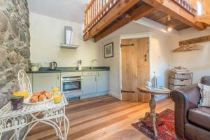 a kitchen with a table with a plate of food on it at Ty-Gwair-Byrdir in Dyffryn +8 photos