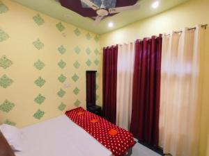 a bedroom with a bed with polka dot curtains at Mishra Guesthouse in Varanasi