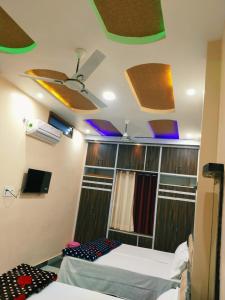 a room with two beds and some lights on the ceiling at Mishra Guesthouse in Varanasi