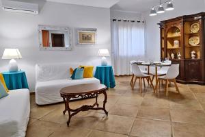 a living room with a couch and a table at Villa Paradiso in Scopello