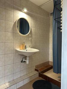a bathroom with a sink and a mirror at Pola 1 in Świnoujście