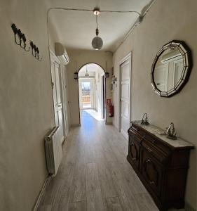 a bathroom with a sink and a mirror and a hallway at Mas Sara in Cabanes