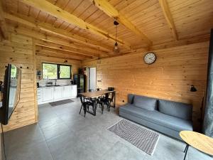 a living room with a couch and a table at Stodoły na Mierzei in Kąty Rybackie +17 photos