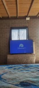 a blue box in a room with a window at La vista más linda del oriente in Guarne