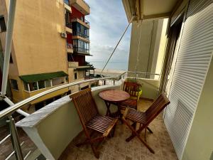 a balcony with two chairs and a table on a balcony at Villa Arberia in Durrës