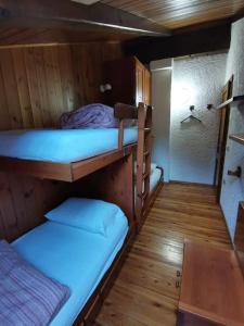 a room with two bunk beds in a cabin at Mansarda trilocale direttamente sulla pista a Folgarida - Belvedere in Folgarida