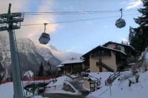 a ski resort with a ski lift in the snow at Mansarda trilocale direttamente sulla pista a Folgarida - Belvedere in Folgarida