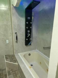 a bath tub in a bathroom with a shower at Hotel Boutique TEKALI INN in Cuetzalán del Progreso