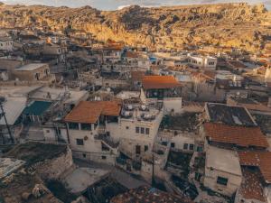 an aerial view of a village with mountains in the background at Zula Cave House in Urgup