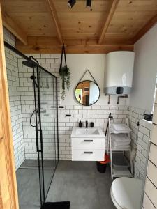 a bathroom with a sink and a mirror at Stodoły na Mierzei in Kąty Rybackie