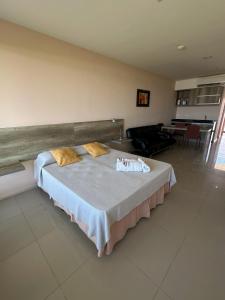 a bedroom with a bed and a living room at Audencia del Mar in La Paloma
