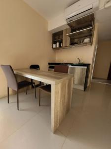 a kitchen with a wooden table and chairs at Audencia del Mar in La Paloma