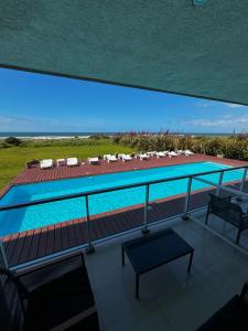 a view of a swimming pool from the balcony of a house at Audencia del Mar in La Paloma