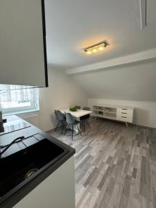 a kitchen with a table and chairs in a room at Apartment Vlora 2-Naturblick in Villach