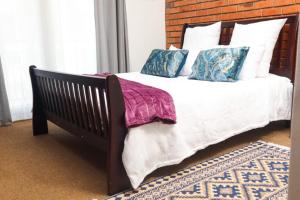 a bedroom with a bed with white sheets and pillows at Spacious and luxury 3 bedroom apartment in Midrand