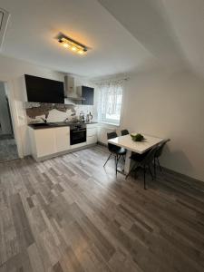 a kitchen and dining room with a table and chairs at Apartment Vlora 2-Naturblick in Villach