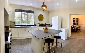 a kitchen with a island with a bowl of fruit on it at Moortown House in Market Rasen