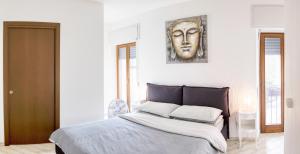a bedroom with a bed with a mask on the wall at Ballatoio Apartment by the Lake in Lesa