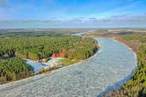 an aerial view of a river with a house at Nemuno Slėnis in Birštonas