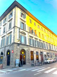 żółto-biały budynek przy ulicy miejskiej w obiekcie CASA MICOL - Centro Ƒirenze we Florencji