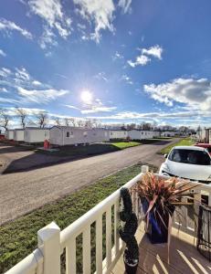 a balcony with a white fence and a car on a road at 35 Irby way in Lincolnshire