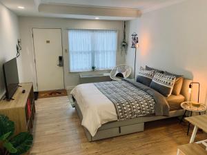 a bedroom with a large bed and a window at Urban Nest, Studio, Ground Floor in Halifax